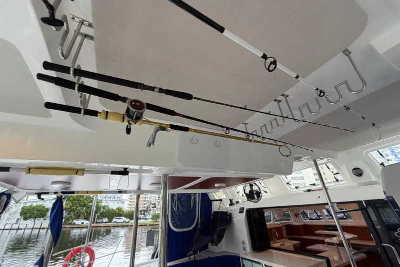 Calacoto Yacht Photos Pics Interior of 2023 Royal Cape Catamarans Majestic 530 with fishing rods stored overhead.