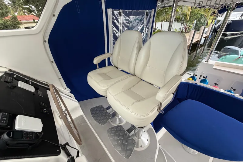 Calacoto Yacht Photos Pics Helm seating area on 2023 Royal Cape Catamarans Majestic 530 with dual white captain chairs.