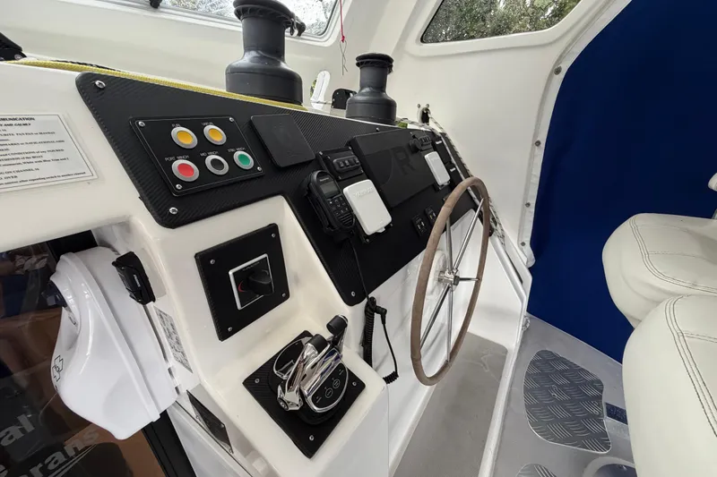 Calacoto Yacht Photos Pics Helm station of 2023 Royal Cape Catamarans Majestic 530 with controls and steering wheel.