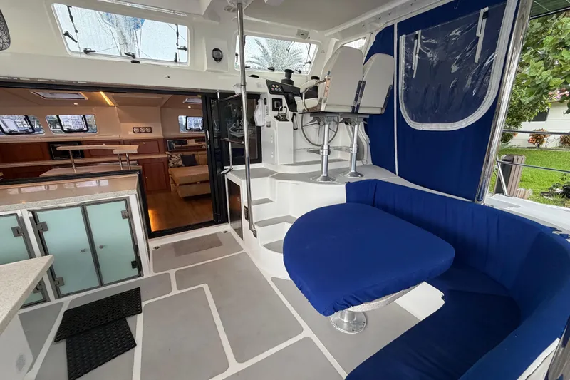Calacoto Yacht Photos Pics Luxurious 2023 Royal Cape Catamarans Majestic 530 interior with modern seating and helm station.