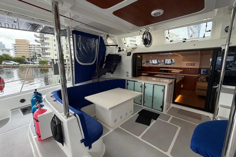 Calacoto Yacht Photos Pics Luxurious 2023 Royal Cape Catamarans Majestic 530 interior with seating and dining area.
