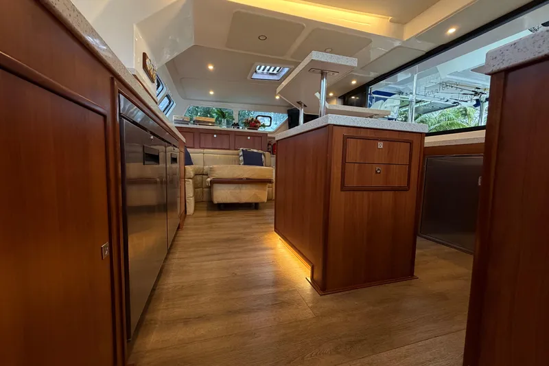 Calacoto Yacht Photos Pics Luxurious interior of 2023 Royal Cape Catamarans Majestic 530 with modern wood finishes.