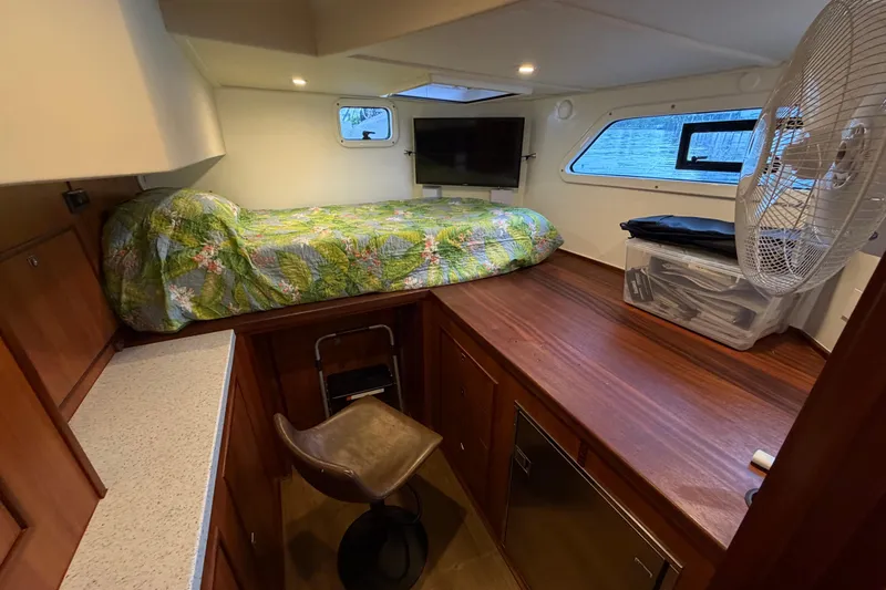 Calacoto Yacht Photos Pics 2023 Royal Cape Catamarans Majestic 530 cabin with bed, TV, and fan.