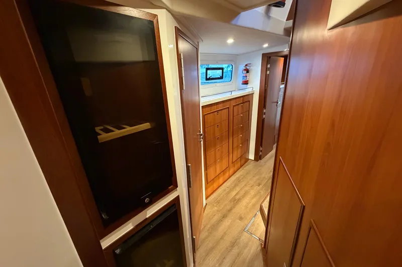 Calacoto Yacht Photos Pics Interior of 2023 Royal Cape Catamarans Majestic 530, featuring wood cabinetry and modern design.