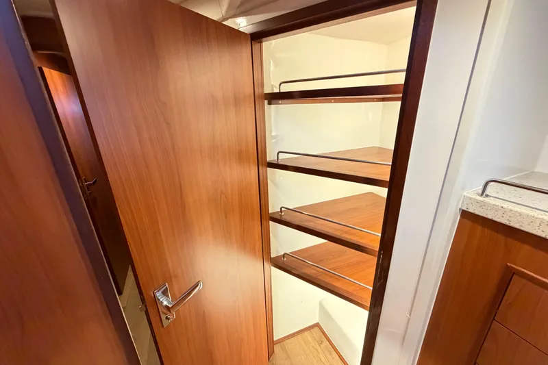 Calacoto Yacht Photos Pics Wooden pantry shelves inside the 2023 Royal Cape Catamarans Majestic 530.