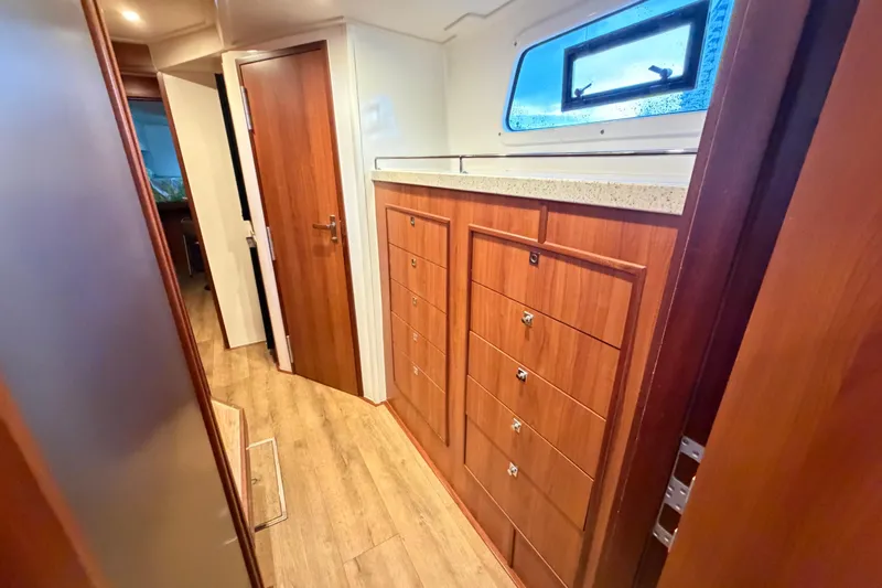 Calacoto Yacht Photos Pics Interior of 2023 Royal Cape Catamarans Majestic 530, featuring wooden cabinetry and modern design.