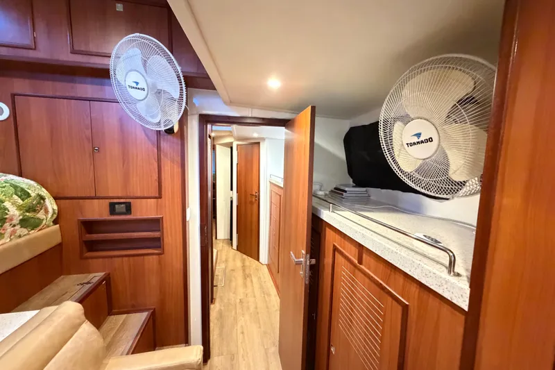 Calacoto Yacht Photos Pics Interior of 2023 Royal Cape Catamarans Majestic 530 with wood paneling and fans.