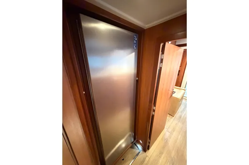 Calacoto Yacht Photos Pics Interior view of 2023 Royal Cape Catamarans Majestic 530, featuring sleek wooden cabinetry.