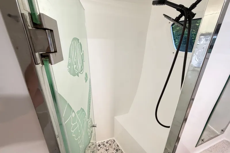 Calacoto Yacht Photos Pics Shower area in 2023 Royal Cape Catamarans Majestic 530 with glass door and modern fixtures.