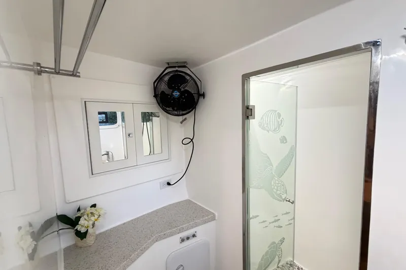 Calacoto Yacht Photos Pics Modern bathroom in 2023 Royal Cape Catamarans Majestic 530 with glass shower and fan.