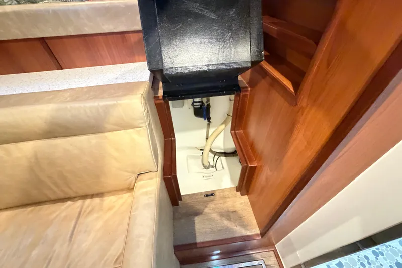 Calacoto Yacht Photos Pics Interior view of 2023 Royal Cape Catamarans Majestic 530, featuring wooden cabinetry and seating.