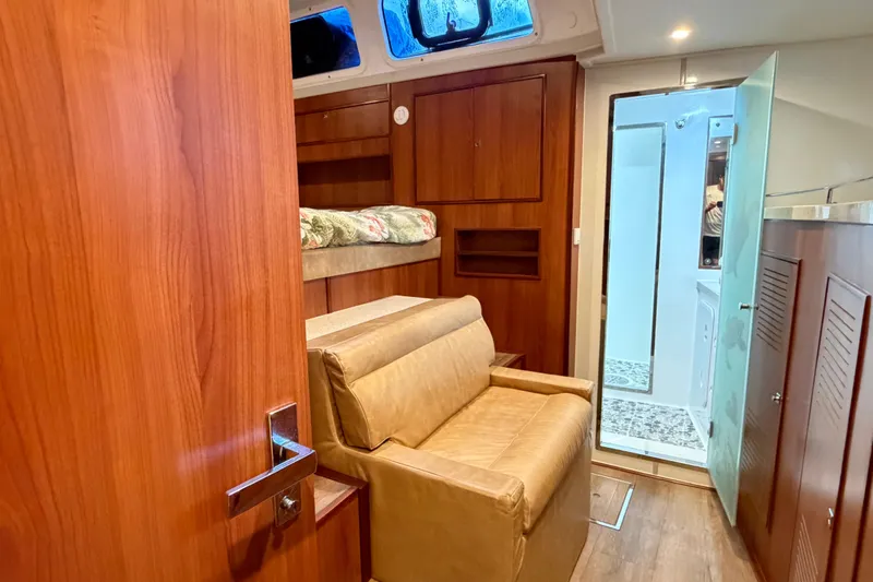 Calacoto Yacht Photos Pics Luxurious interior of 2023 Royal Cape Catamarans Majestic 530, featuring wood finishes and cozy seating.
