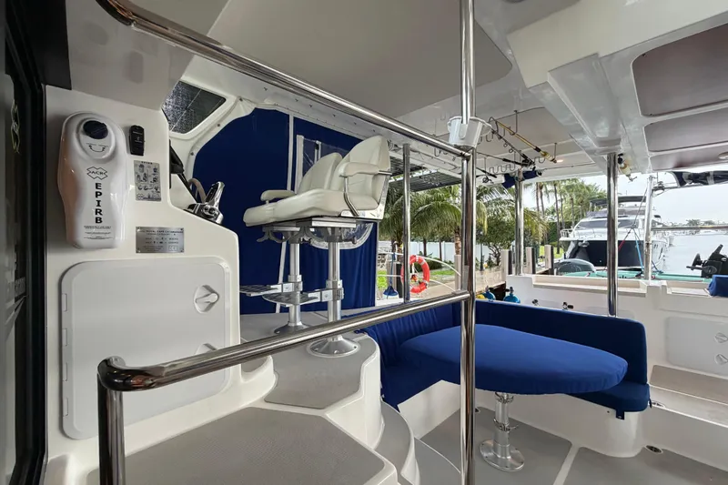 Calacoto Yacht Photos Pics Luxurious 2023 Royal Cape Catamarans Majestic 530 interior with seating and navigation equipment.