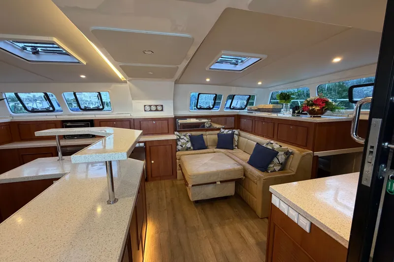 Calacoto Yacht Photos Pics Luxurious interior of 2023 Royal Cape Catamarans Majestic 530 with modern seating and elegant decor.