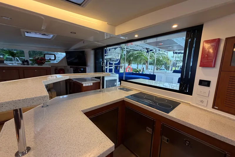 Calacoto Yacht Photos Pics Luxurious kitchen interior of 2023 Royal Cape Catamarans Majestic 530 with modern appliances.