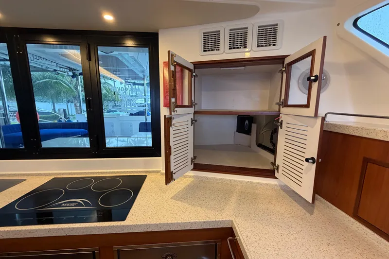 Calacoto Yacht Photos Pics Modern kitchen interior of 2023 Royal Cape Catamarans Majestic 530 with open cabinets.