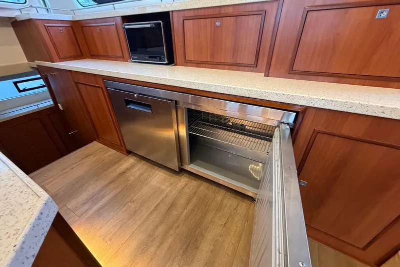 Calacoto Yacht Photos Pics Luxurious kitchen interior of 2023 Royal Cape Catamarans Majestic 530 with modern appliances.