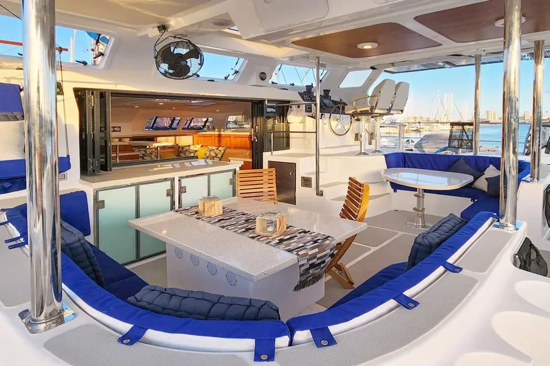 Calacoto Yacht Photos Pics Luxurious 2023 Royal Cape Catamarans Majestic 530 yacht interior with elegant seating and dining area.