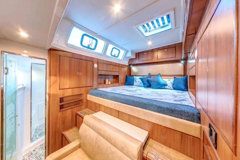 Calacoto Yacht Photos Pics Luxurious cabin interior of 2023 Royal Cape Catamarans Majestic 530 with elegant wood finish.