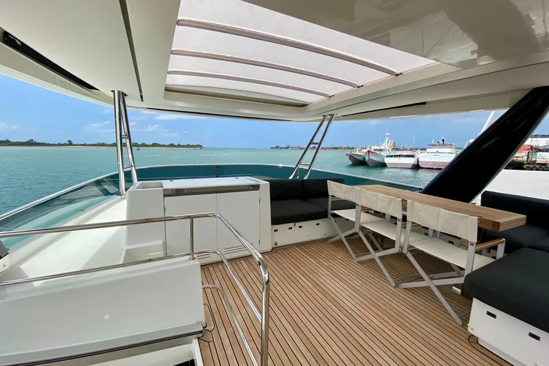  Yacht Photos Pics Luxurious 2017 Lagoon 630 Motor Yacht deck with seating, table, and ocean view.