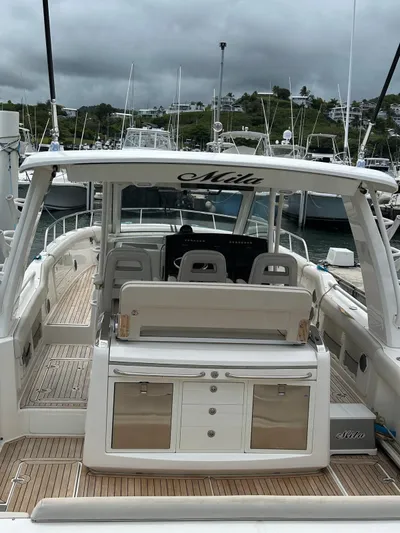  Yacht Photos Pics 2015 Boston Whaler 420 Outrage boat docked, featuring spacious seating and sleek design.