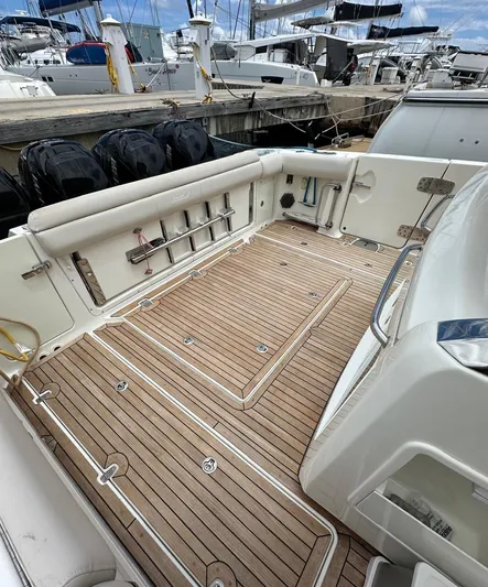  Yacht Photos Pics 2015 Boston Whaler 420 Outrage boat deck with wood finish, docked at marina.