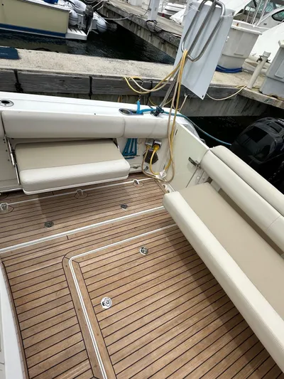  Yacht Photos Pics 2015 Boston Whaler 420 Outrage boat with teak deck and beige seating at a marina.