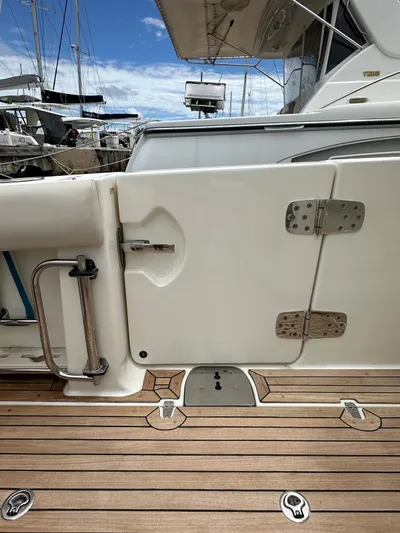  Yacht Photos Pics Boston Whaler 420 Outrage 2015 boat deck with open side door, marina background.