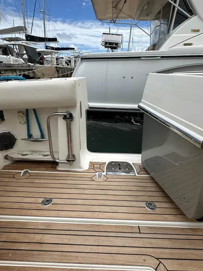  Yacht Photos Pics Boston Whaler 420 Outrage 2015 boat deck with wooden flooring, docked at marina.