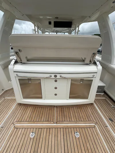  Yacht Photos Pics 2015 Boston Whaler 420 Outrage interior with open storage and teak flooring.