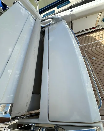  Yacht Photos Pics 2015 Boston Whaler 420 Outrage boat deck with sleek white seating and wooden flooring.