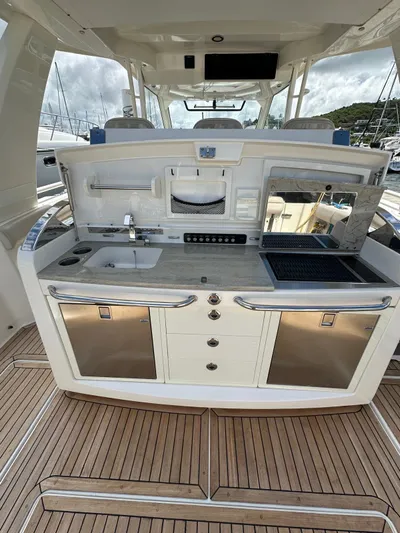  Yacht Photos Pics 2015 Boston Whaler 420 Outrage yacht kitchen with modern amenities and sleek design.