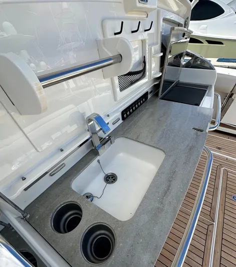  Yacht Photos Pics 2015 Boston Whaler 420 Outrage boat kitchen with sink and countertop.