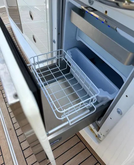  Yacht Photos Pics Open drawer refrigerator on 2015 Boston Whaler 420 Outrage boat, showing storage compartments.