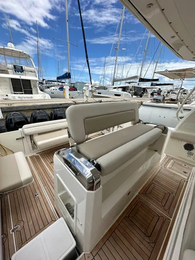  Yacht Photos Pics 2015 Boston Whaler 420 Outrage boat interior with luxurious seating and marina view.