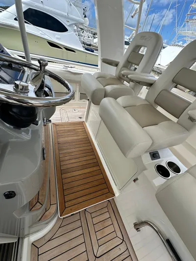  Yacht Photos Pics 2015 Boston Whaler 420 Outrage interior with helm seats and teak flooring.