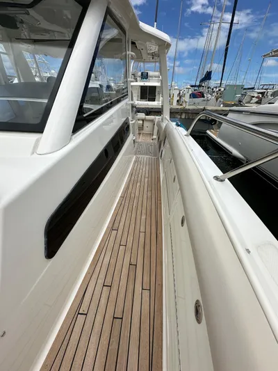  Yacht Photos Pics 2015 Boston Whaler 420 Outrage boat with sleek deck and marina view.