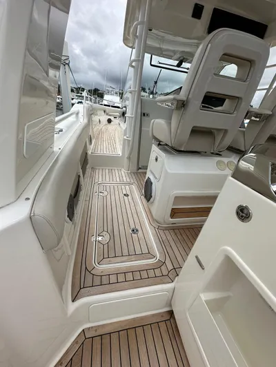  Yacht Photos Pics 2015 Boston Whaler 420 Outrage interior with sleek seating and wooden deck.