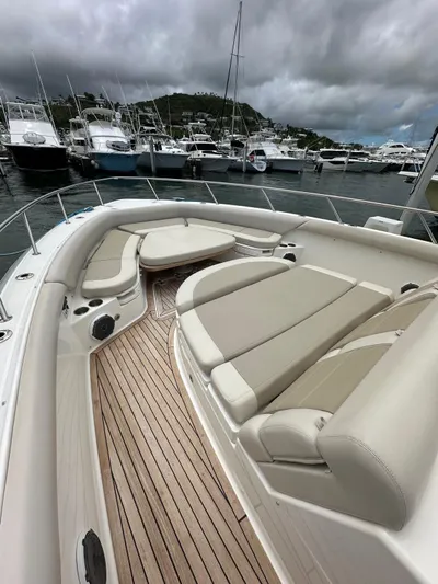  Yacht Photos Pics 2015 Boston Whaler 420 Outrage boat with spacious deck, docked in a marina under cloudy skies.