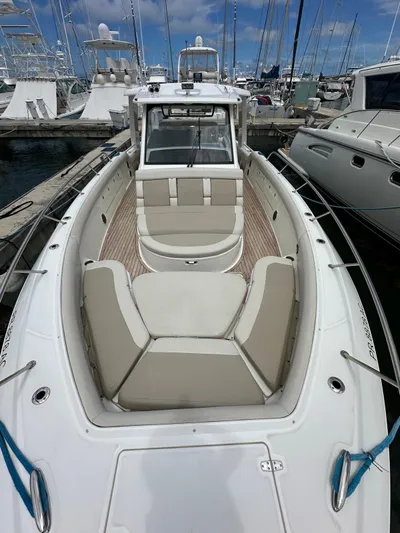  Yacht Photos Pics 2015 Boston Whaler 420 Outrage boat docked, featuring spacious seating and sleek design.