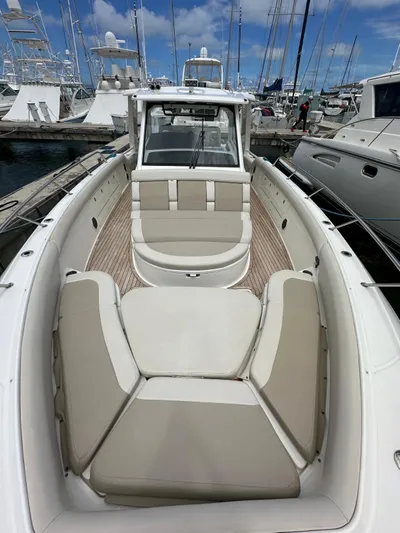  Yacht Photos Pics 2015 Boston Whaler 420 Outrage boat with spacious seating, docked at a marina.