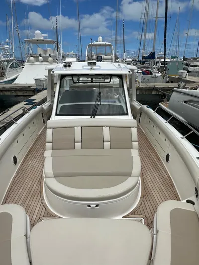  Yacht Photos Pics 2015 Boston Whaler 420 Outrage boat docked in a marina with clear skies.