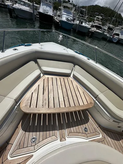  Yacht Photos Pics 2015 Boston Whaler 420 Outrage boat with teak deck and cushioned seating in marina.