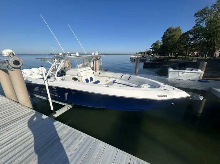  Yacht Photos Pics 2016 Midnight Express 37 Open boat docked by a serene waterfront.