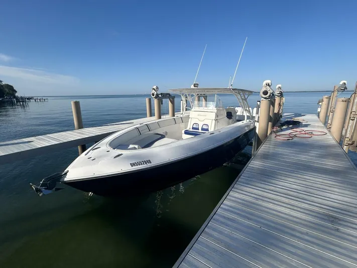  Yacht Photos Pics 2016 Midnight Express 37 Open boat docked on calm water under clear blue sky.
