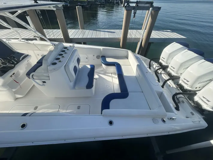  Yacht Photos Pics 2016 Midnight Express 37 Open boat with spacious seating and powerful engines docked by the water.