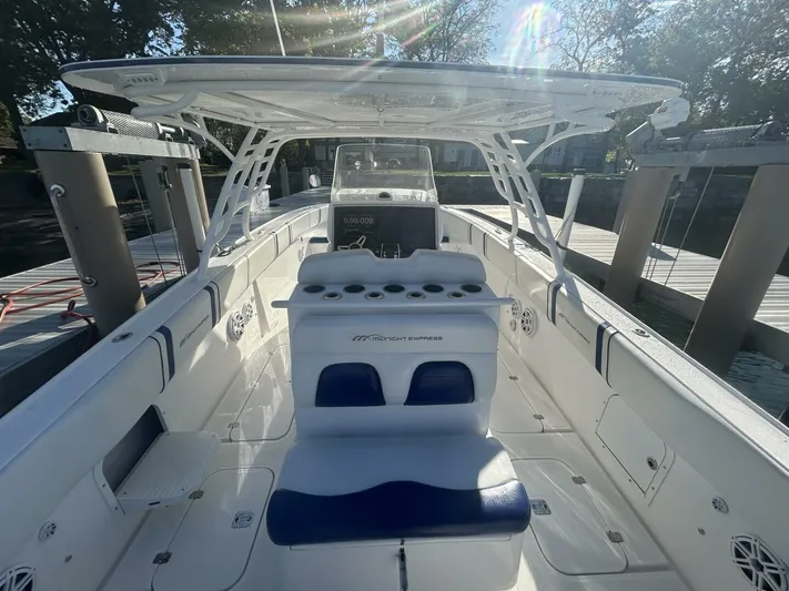  Yacht Photos Pics 2016 Midnight Express 37 Open boat with sleek white and blue interior, docked in sunlight.