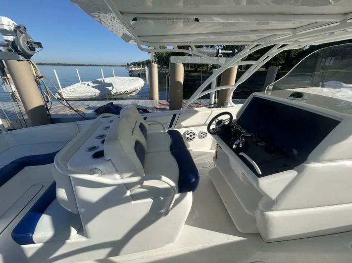  Yacht Photos Pics 2016 Midnight Express 37 Open boat interior with helm and seating, docked by the water.