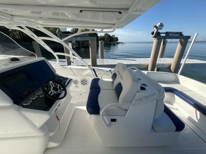  Yacht Photos Pics 2016 Midnight Express 37 Open boat cockpit with modern controls and seating by the water.