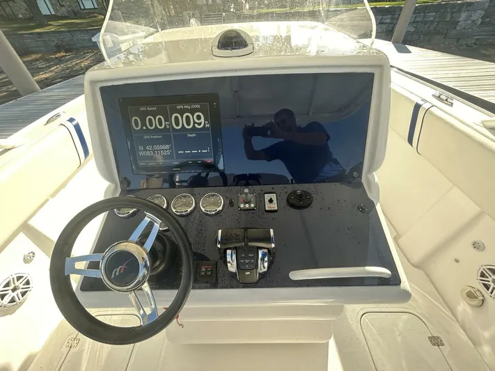  Yacht Photos Pics Cockpit of 2016 Midnight Express 37 Open boat with steering wheel and digital display.